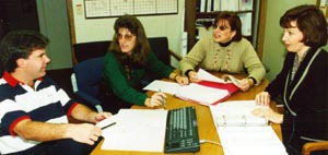 Business Services members discussing Costpoint