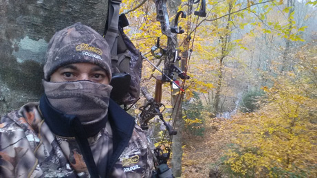 Jenord Alston bow hunting - in woods with compound bow
