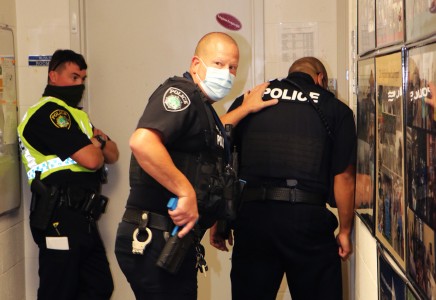 Two NNPD officers speak to an exercise participant through a "locked" door