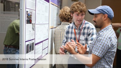 A student presents a poster during the 2018 Summer Intern Poster Session
