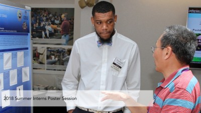 A student presents a poster during the 2018 Summer Intern Poster Session