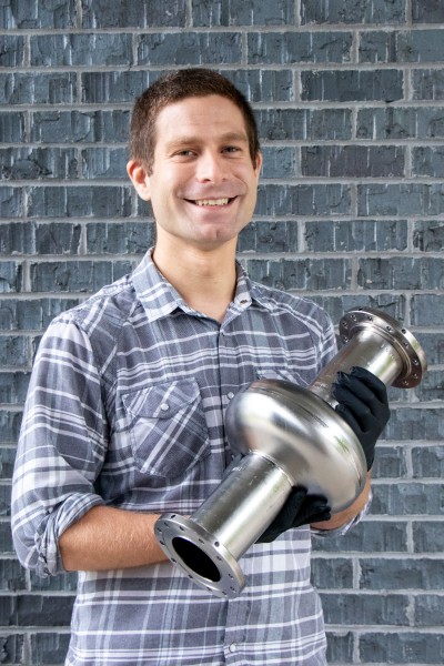 Eric Lechner shows the oxygen-alloyed, single-cell niobium cavity