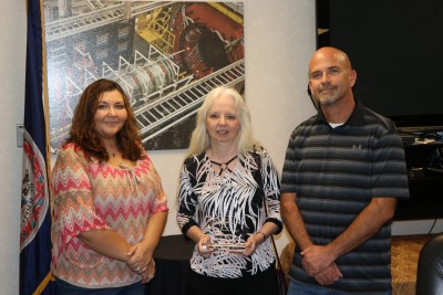 Elaine Claiborne accepts the 2018 Small Business of the Year award; Michele Khasidis and Scott Conley nominated the company