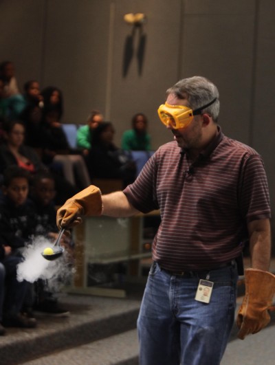 Steve Gagnon holds a ball in a ladle filled with liquid nitrogen